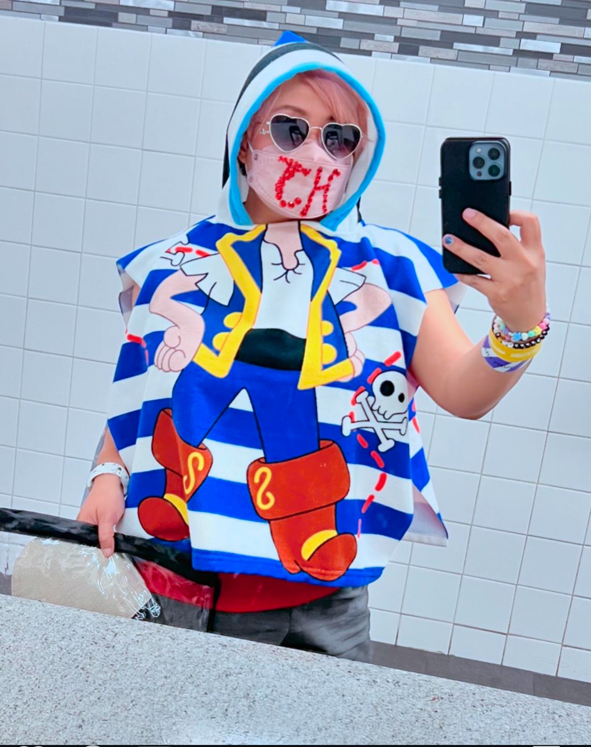 bathroom mirror selfie wearing a kids' pirate-themed hooded towel